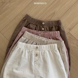 بنطلون فضفاض للأطفال بتصميم خصر مطاطي وأزرار امامية، مصنوع من قماش قطني ناعم