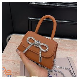 شنطه نسائي صغيره الحجم على شكل فيونكا 